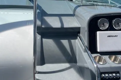 Slide: The Image of 2014 Formula 370 Super Sport boat dashboard with Mercury controls and cup holders. - 13