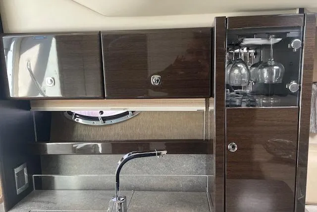 Slide: The Image of 2014 Formula 370 Super Sport yacht interior with sleek cabinetry and glassware storage. - 16