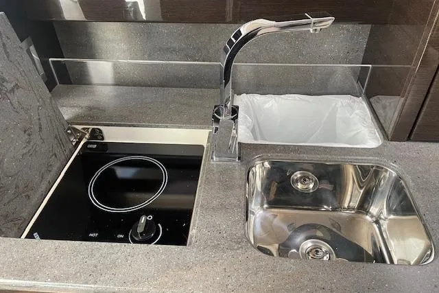 Slide: The Image of 2014 Formula 370 Super Sport kitchen with stove, sink, and modern faucet. - 17