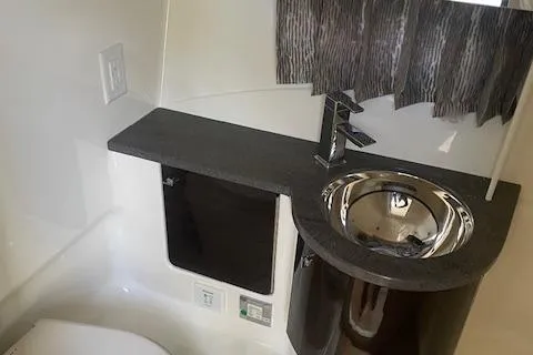 Slide: The Image of 2014 Formula 370 Super Sport bathroom with modern sink and sleek countertop design. - 21