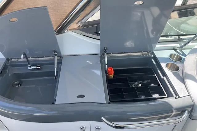 Slide: The Image of 2014 Formula 370 Super Sport boat with open storage compartments and sink. - 4