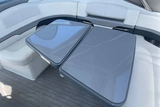 Slide: The Image of 2014 Formula 370 Super Sport boat interior with sleek seating and modern tables. - 8