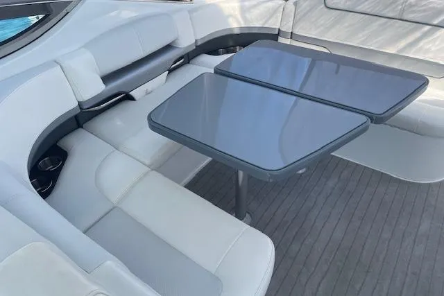Slide: The Image of 2014 Formula 370 Super Sport boat interior with sleek seating and dual tables. - 9