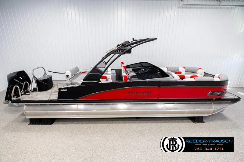 The Image of 2026 Avalon CAT CRBW pontoon boat, red and black design, displayed indoors. - 1