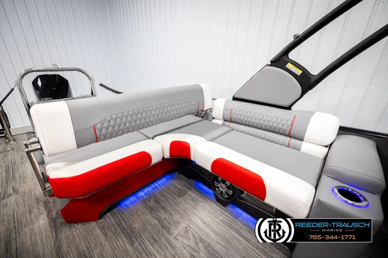 Slide: The Image of Luxurious 2026 Avalon CAT CRBW boat interior with gray and red seating, blue LED lighting. - 23