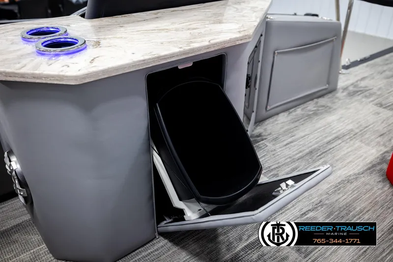 Slide: The Image of 2026 Avalon CAT CRBW boat interior with storage compartment and illuminated cup holders. - 29