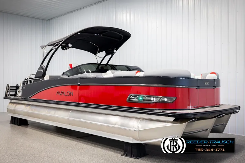 Slide: The Image of 2026 Avalon CAT CRBW pontoon boat in showroom, featuring sleek red and black design. - 3
