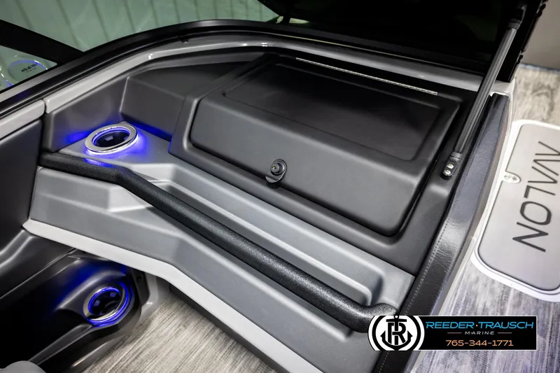Slide: The Image of 2026 Avalon CAT CRBW boat interior with illuminated cup holders and storage compartment. - 42