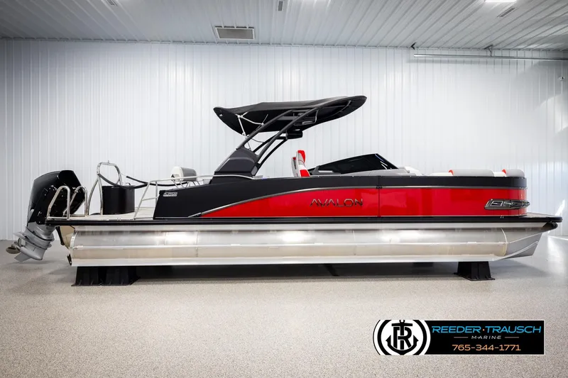 Slide: The Image of 2026 Avalon CAT CRBW pontoon boat in showroom, featuring sleek red and black design. - 5