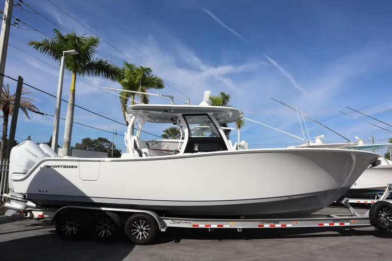 The Image of 2026 Sportsman Open 322 Center Console boat displayed in a showroom. - 0