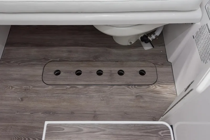 Slide: The Image of 2026 Sportsman Open 322 Center Console boat interior with open storage compartment. - 11