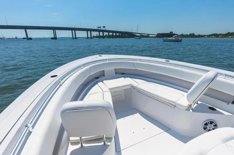 Slide: The Image of 2026 Sportsman Open 322 Center Console boat interior with white seating and modern design. - 12