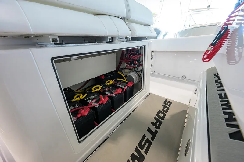 Slide: The Image of 2026 Sportsman Open 322 Center Console battery compartment with wiring and storage. - 23