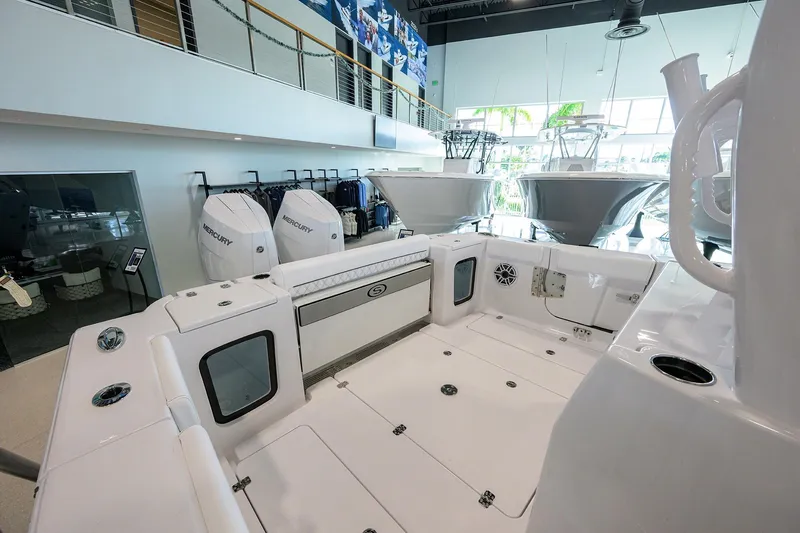 Slide: The Image of 2026 Sportsman Open 322 Center Console boat interior with Mercury engines in showroom. - 26