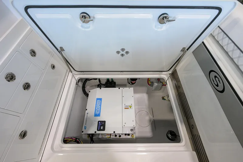 Slide: The Image of 2026 Sportsman Open 322 Center Console storage compartment with electrical unit. - 31