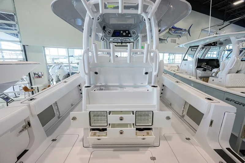 Slide: The Image of 2026 Sportsman Open 322 Center Console boat interior with storage compartments and seating. - 34