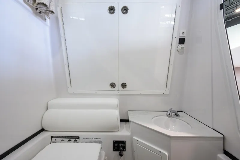 Slide: The Image of 2026 Sportsman Open 322 Center Console interior with sink and storage. - 39