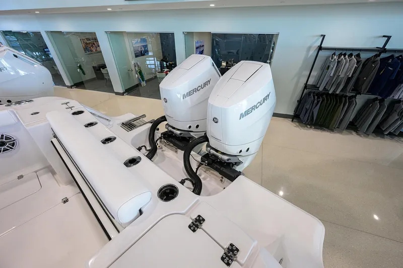 Slide: The Image of 2026 Sportsman Open 322 Center Console with dual Mercury outboard engines in showroom. - 41