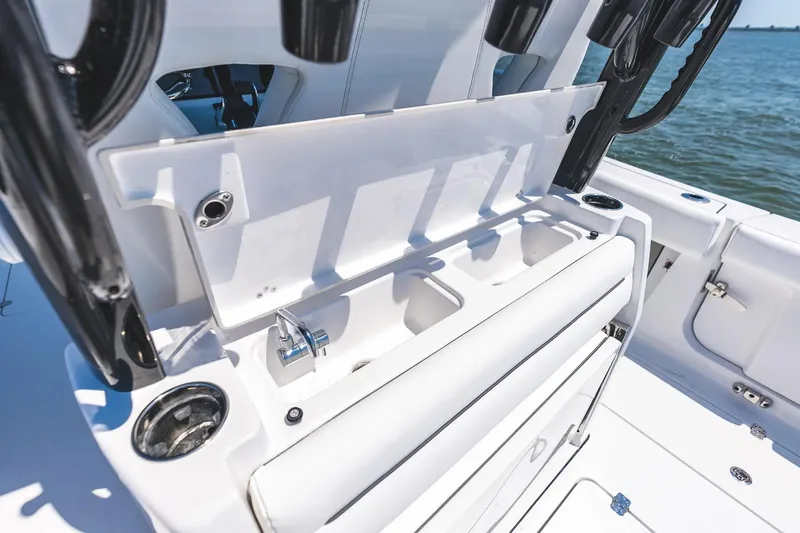 Slide: The Image of 2026 Sportsman Open 322 Center Console boat interior with white seating and modern design. - 6