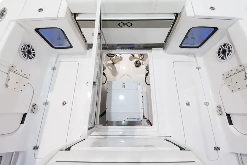 Slide: The Image of 2026 Sportsman Open 322 Center Console boat interior with white seating in showroom. - 8