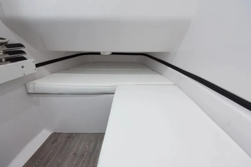 Slide: The Image of 2026 Sportsman Open 322 Center Console boat interior in showroom, featuring luxurious seating. - 9