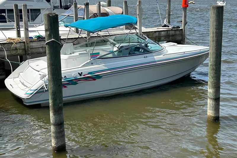 Slide: The Image of 1995 Formula 280 Sun Sport boat docked with blue canopy on a sunny day. - 12