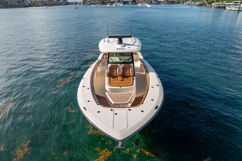 Slide: The Image of 2021 Scout 380 LXF luxury boat on calm water, aerial view. - 10