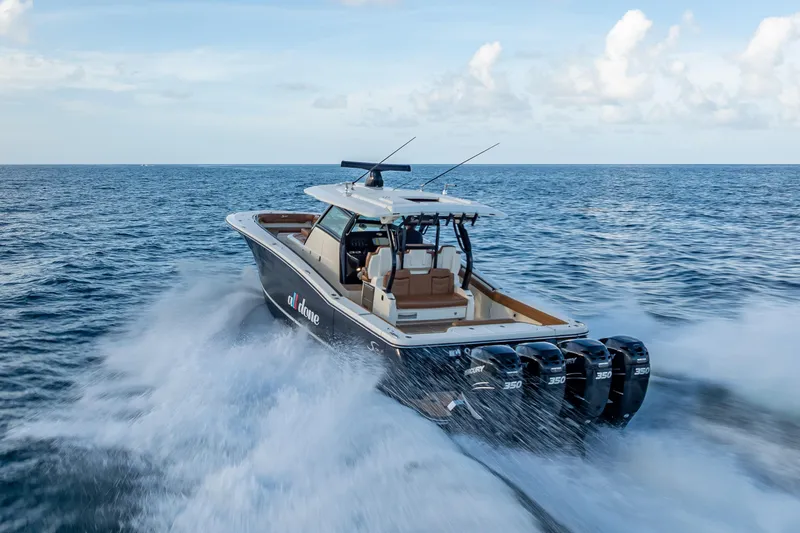 Slide: The Image of 2021 Scout 380 LXF boat cruising on open ocean with powerful engines. - 15