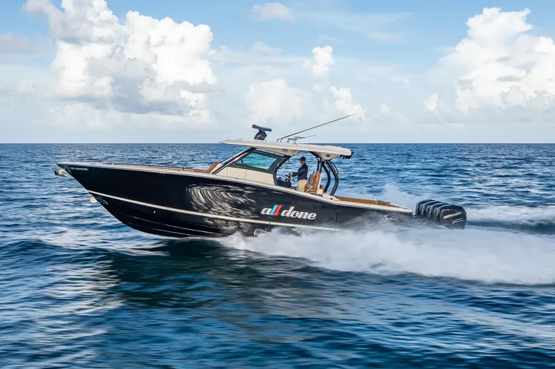 Slide: The Image of 2021 Scout 380 LXF boat cruising on open ocean under clear skies. - 17