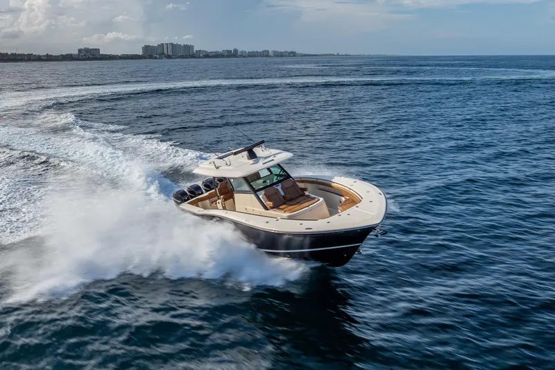 Slide: The Image of 2021 Scout 380 LXF boat cruising on open ocean waters. - 30