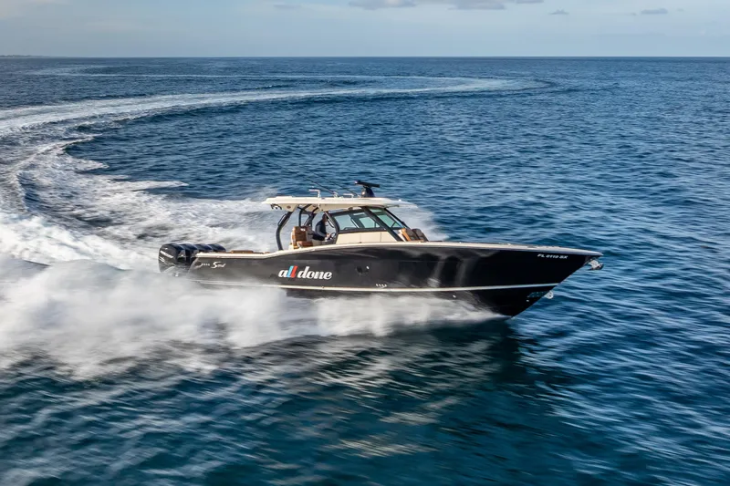 Slide: The Image of 2021 Scout 380 LXF boat cruising swiftly on open water. - 31