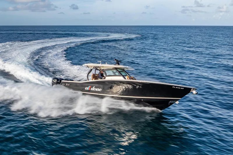 Slide: The Image of 2021 Scout 380 LXF boat cruising swiftly on open ocean waters. - 32