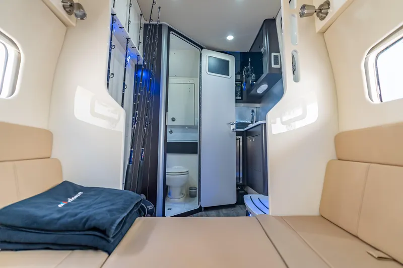 Slide: The Image of Interior of 2021 Scout 380 LXF boat featuring seating, kitchenette, and bathroom. - 36