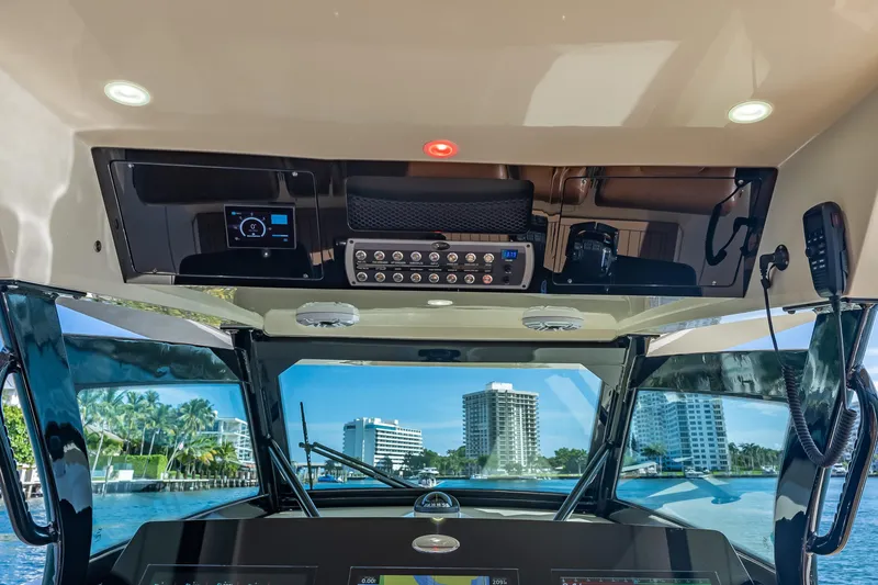 Slide: The Image of Interior view of 2021 Scout 380 LXF boat cockpit with modern controls and cityscape background. - 53