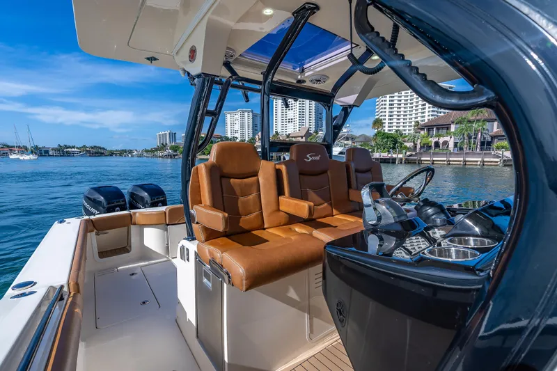 Slide: The Image of 2021 Scout 380 LXF boat interior with luxurious seating and modern dashboard. - 55