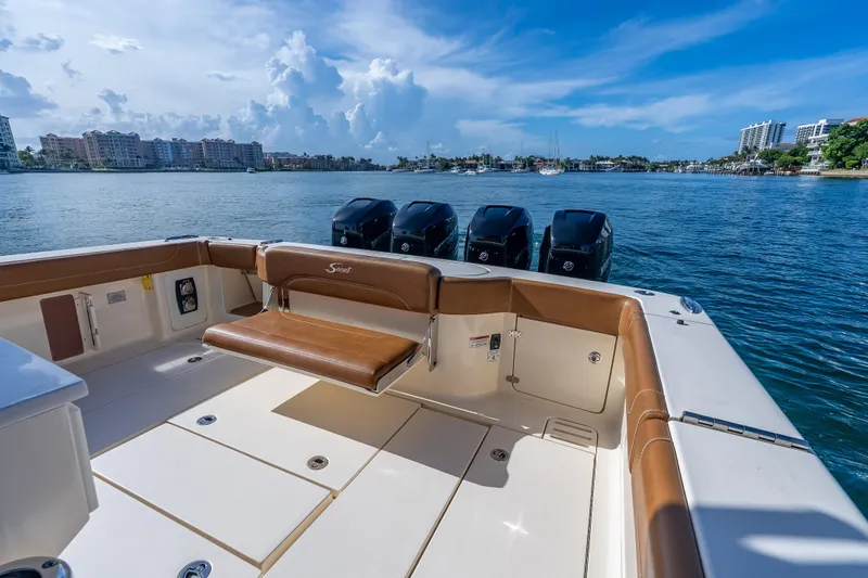 Slide: The Image of 2021 Scout 380 LXF boat with quad engines on a sunny waterfront. - 59