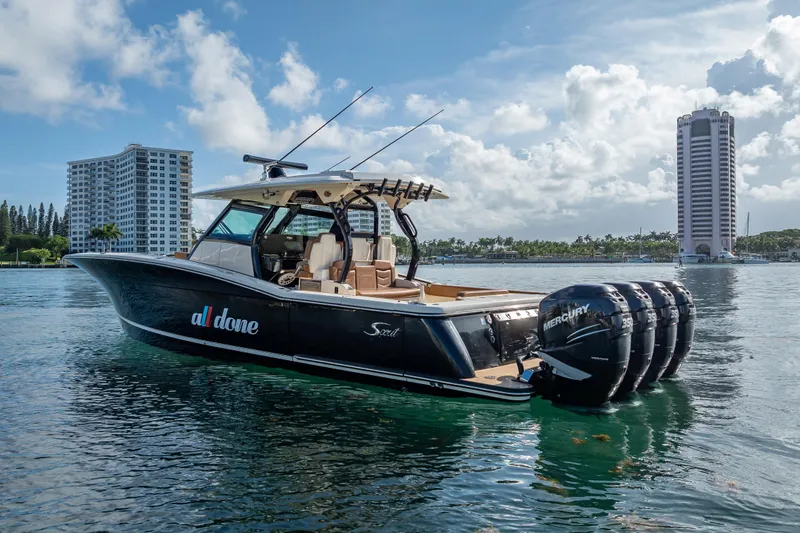 Slide: The Image of 2021 Scout 380 LXF boat on water with cityscape background. - 6