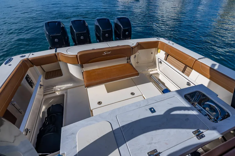 Slide: The Image of 2021 Scout 380 LXF boat interior with luxurious seating and multiple outboard engines. - 60