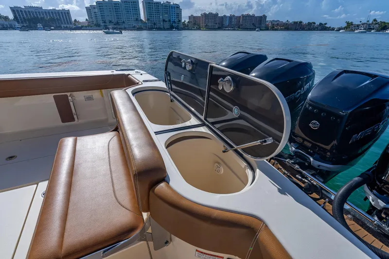 Slide: The Image of 2021 Scout 380 LXF boat interior with seating and dual outboard engines. - 62