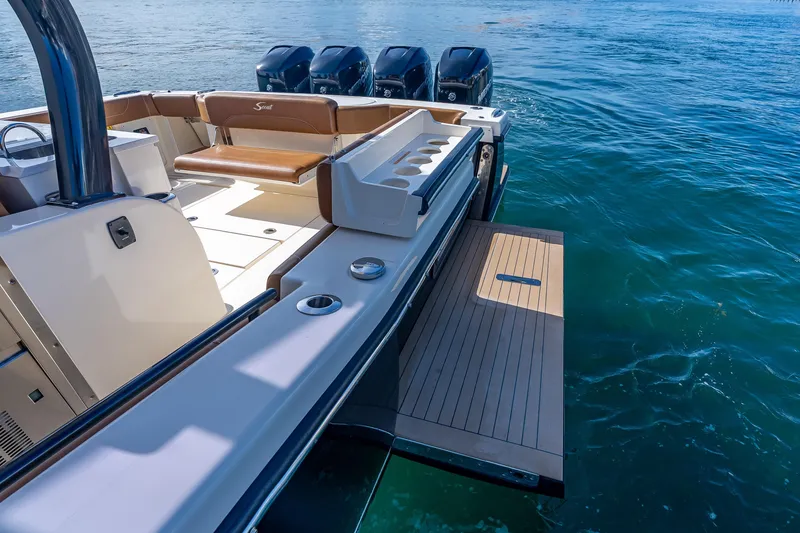 Slide: The Image of 2021 Scout 380 LXF boat with luxurious deck and powerful engines on water. - 63