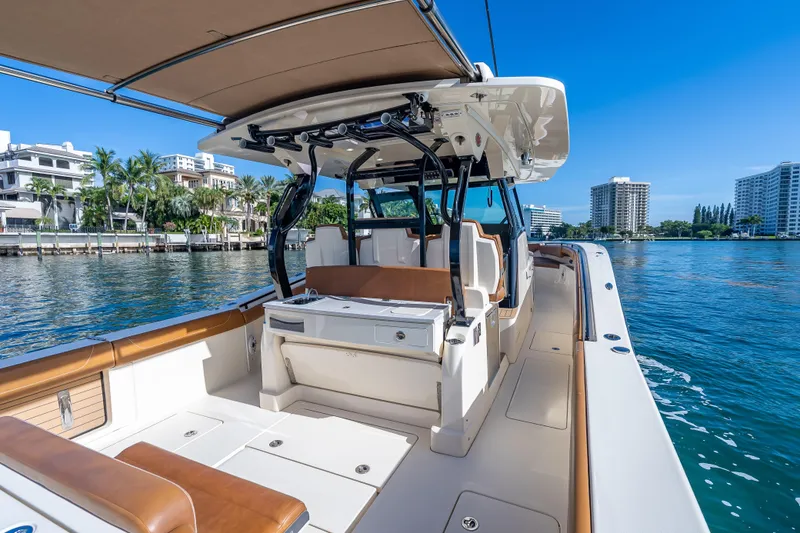 Slide: The Image of 2021 Scout 380 LXF boat on water, luxury interior, cityscape background. - 64