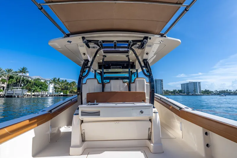 Slide: The Image of 2021 Scout 380 LXF boat on water, featuring sleek design and luxurious seating. - 65