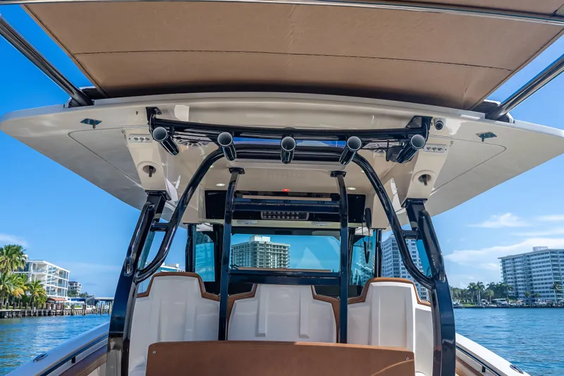 Slide: The Image of 2021 Scout 380 LXF boat with sleek design and modern features, docked by waterfront. - 67