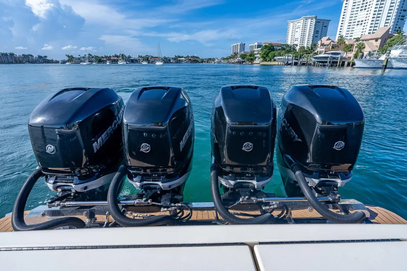 Slide: The Image of 2021 Scout 380 LXF with four powerful Mercury outboard engines on a sunny waterfront. - 69