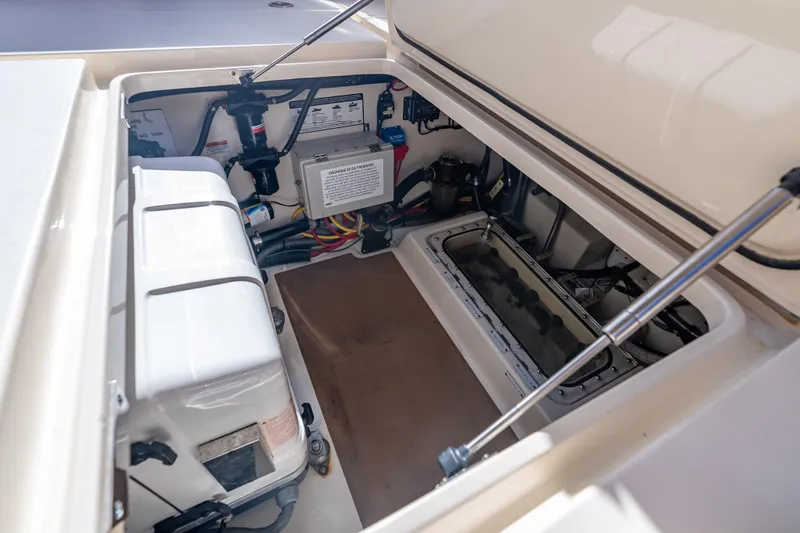 Slide: The Image of 2021 Scout 380 LXF boat storage compartment with electrical components and wiring. - 70