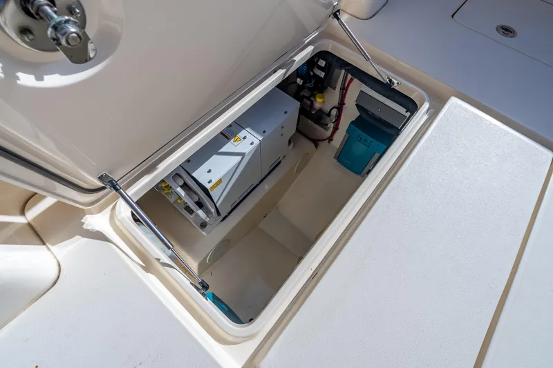 Slide: The Image of 2021 Scout 380 LXF boat storage compartment with equipment and wiring. - 73