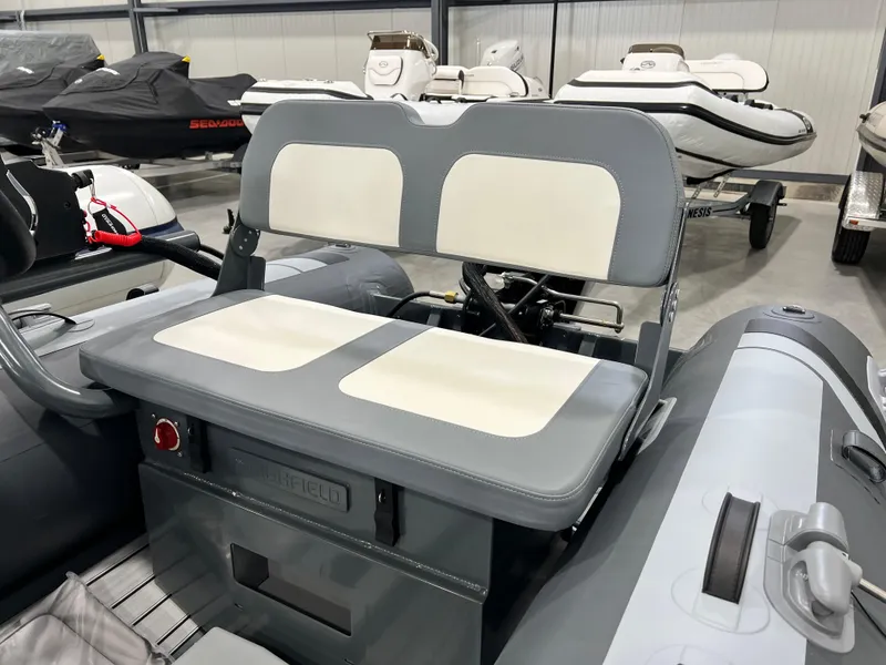 Slide: The Image of 2023 Highfield Classic 310 FCT inflatable boat with dual seating in a showroom. - 3