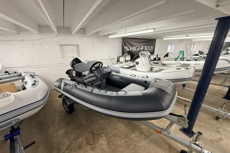 The Image of 2026 Highfield Classic 310 FCT inflatable boat displayed in a showroom. - 9