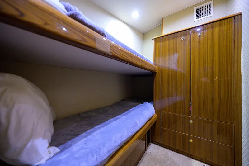 Slide: The Image of Bunk beds and wooden cabinet in 2005 Viking 61 yacht interior. - 11