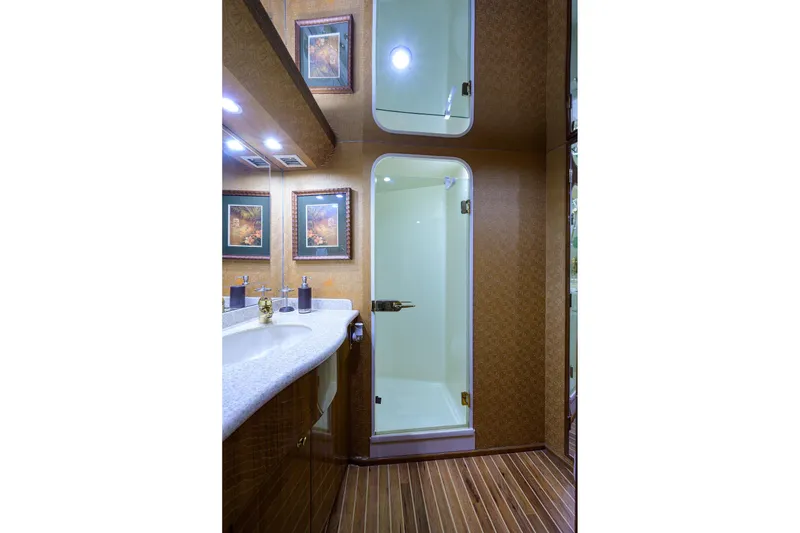 Slide: The Image of Luxurious bathroom in 2005 Viking 61 yacht with shower, vanity, and framed artwork. - 17